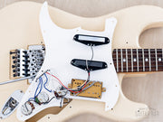 Pickguard lifted showing pickups and wiring