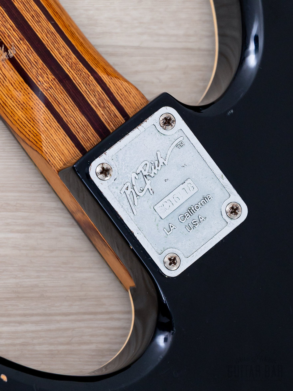 Warlock Bass neck plate and laminate neck close-up