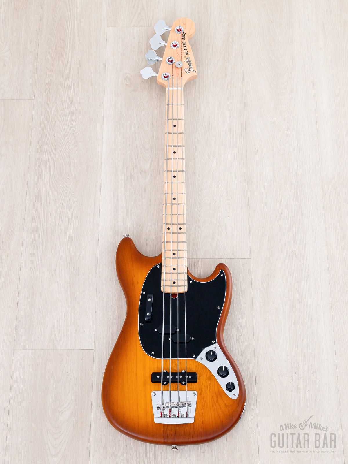 Full front of Honey Burst Mustang Bass with black pickguard
