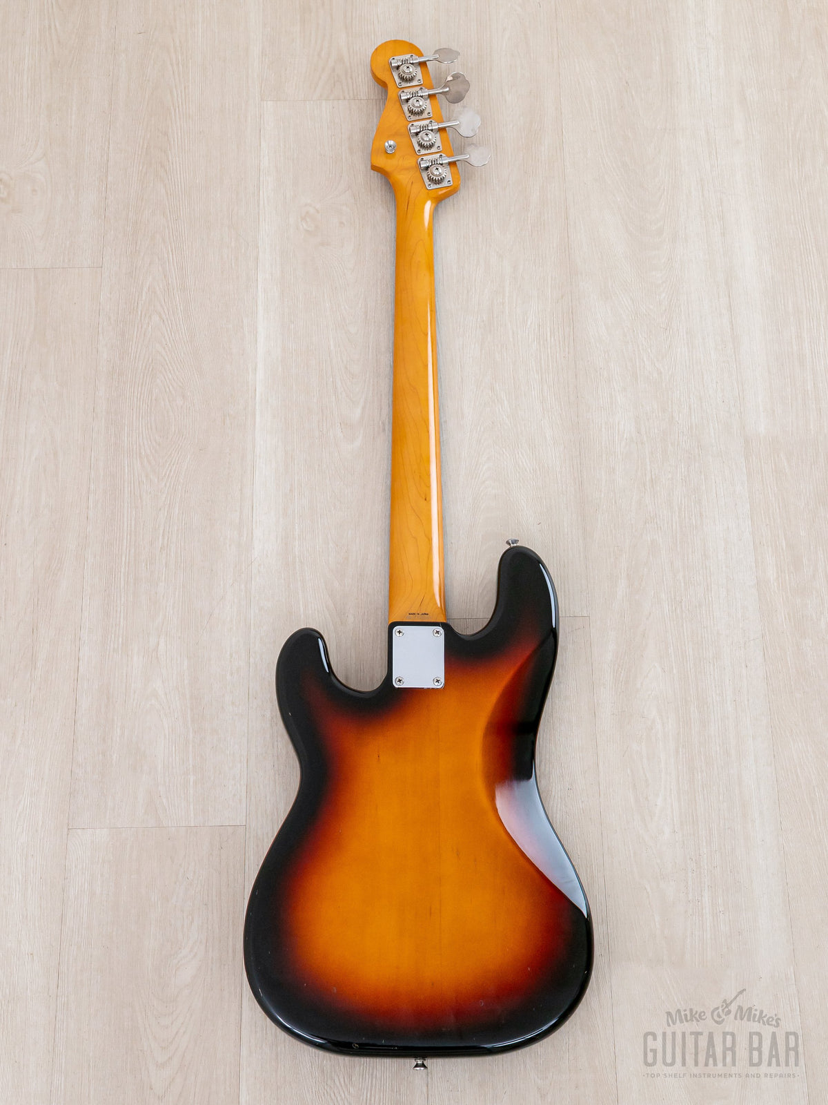 Full back of Sunburst Precision Bass, ambered maple neck