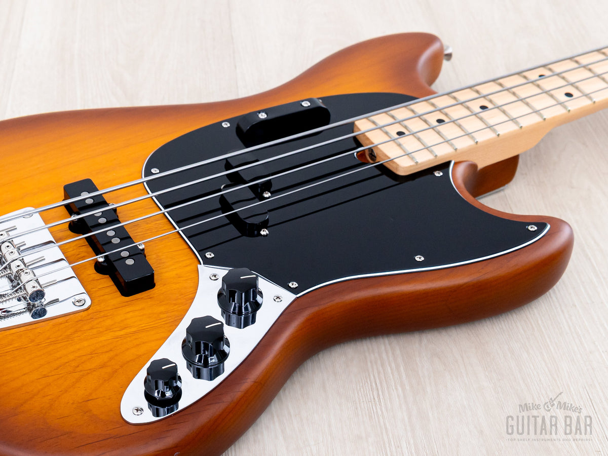 Low angle of body with P and J pickups and control plate