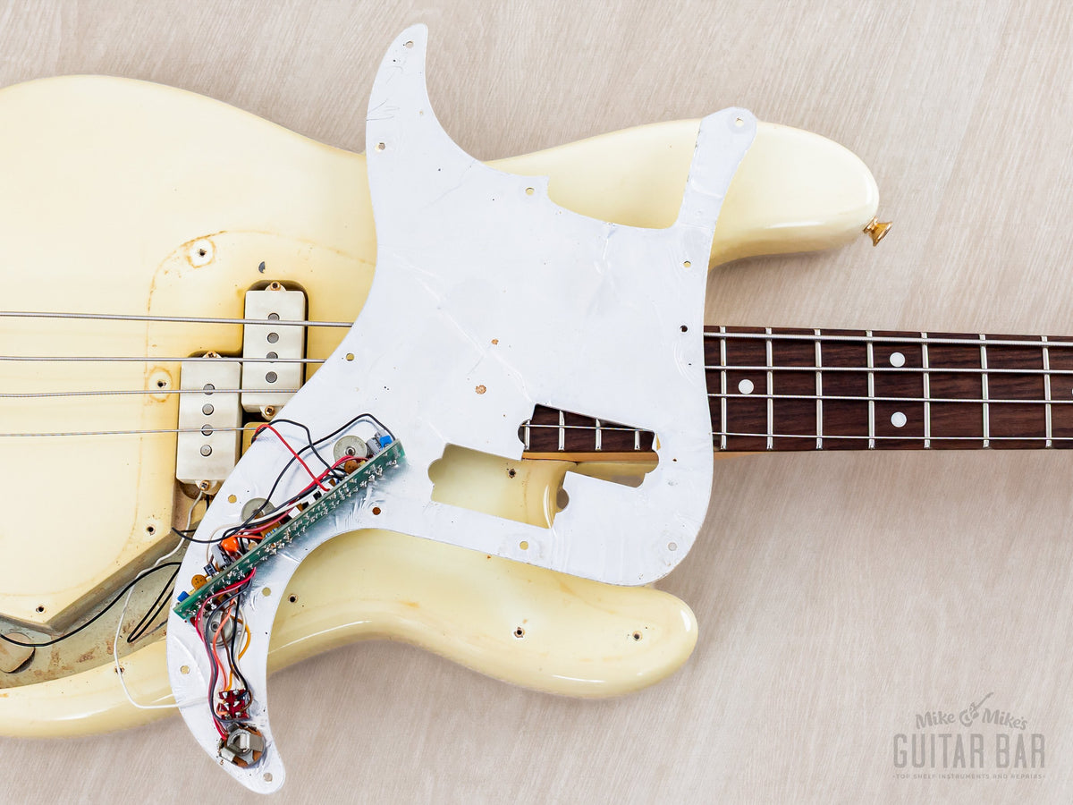 Pickguard lifted, showing active electronics underneath