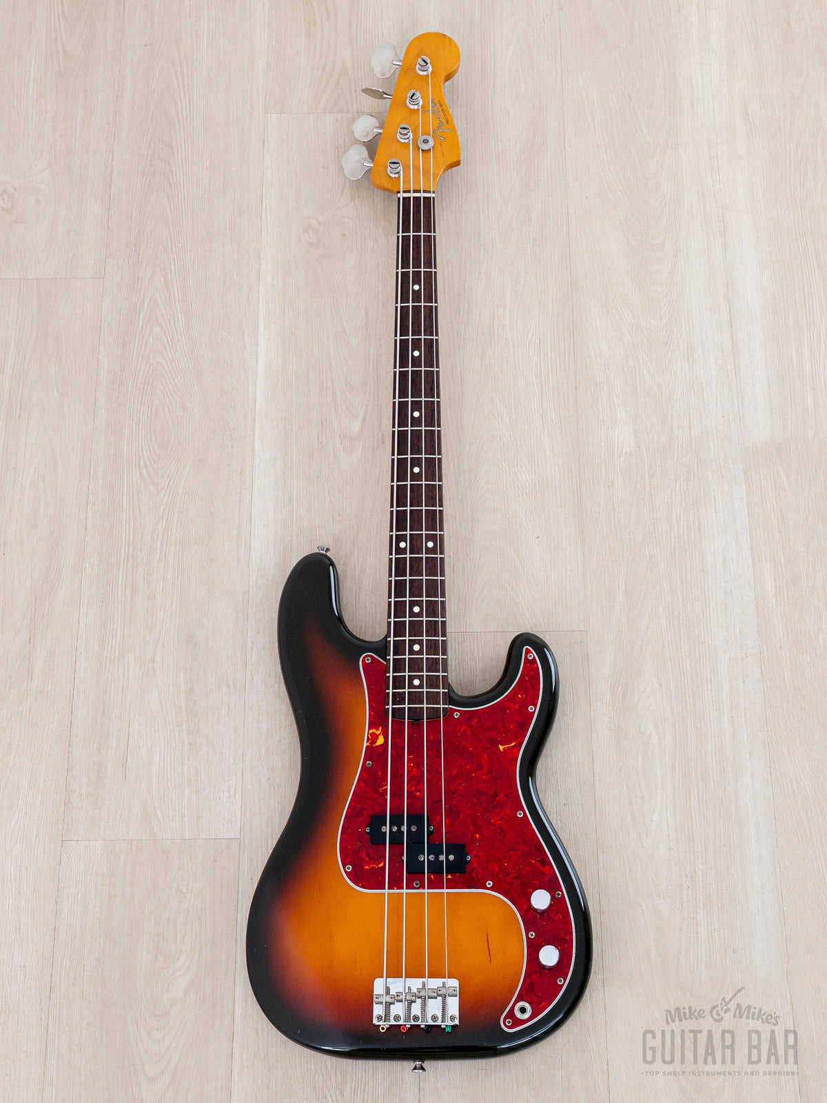 Full front of Sunburst Precision Bass with red tortoise pickguard