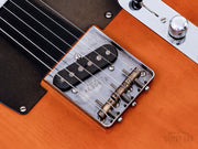 Bridge pickup and brass saddle close-up
