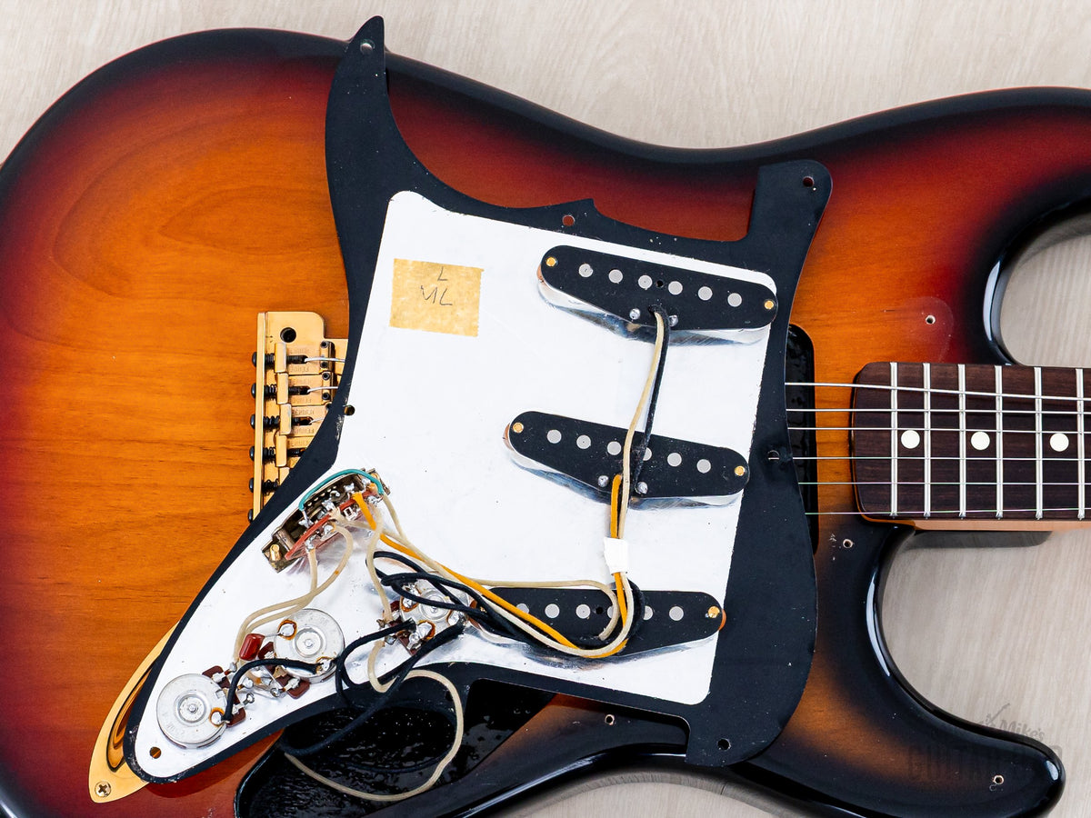 Pickguard lifted showing pickups and original wiring