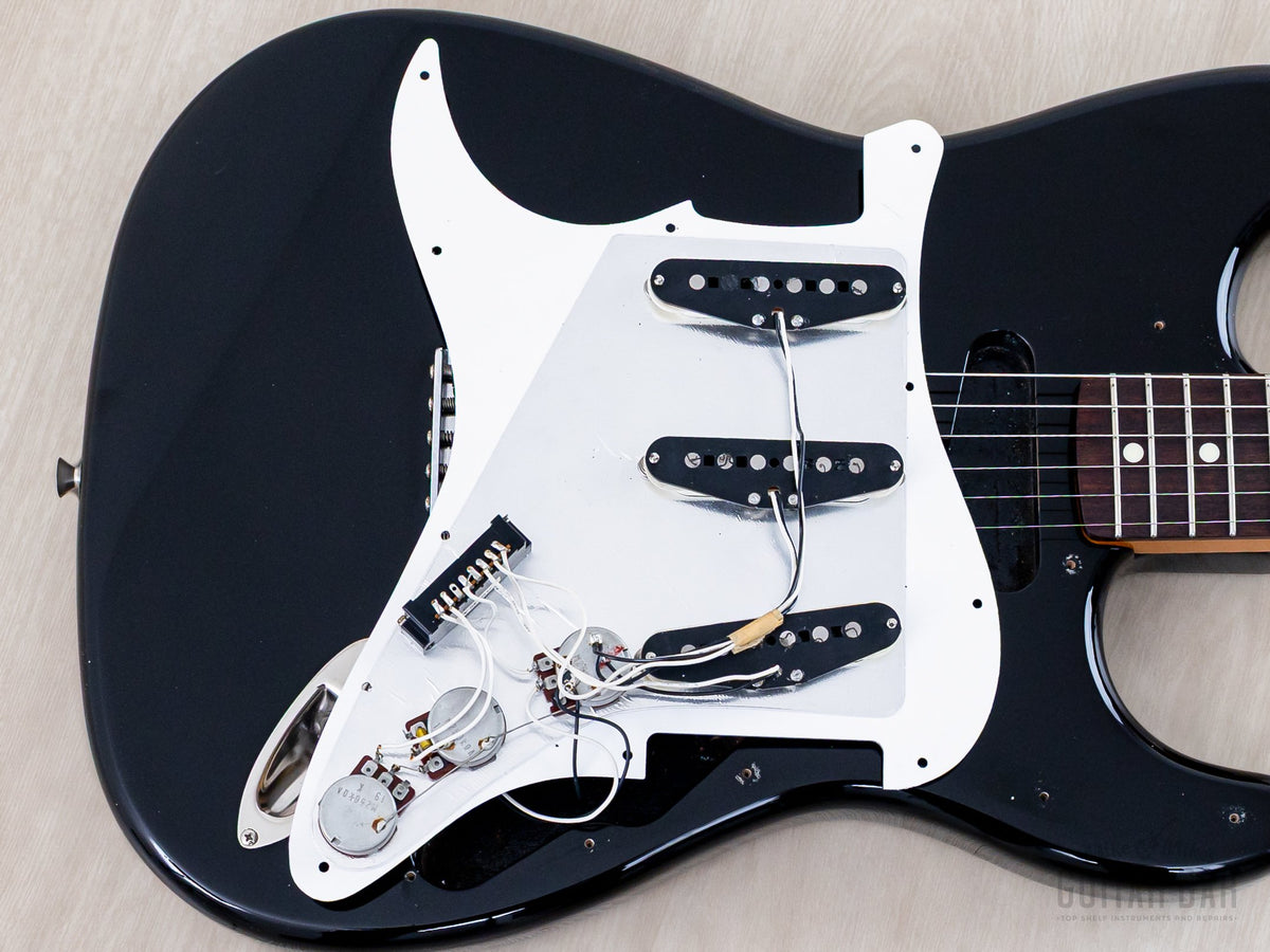 Pickguard lifted showing pickups and wiring